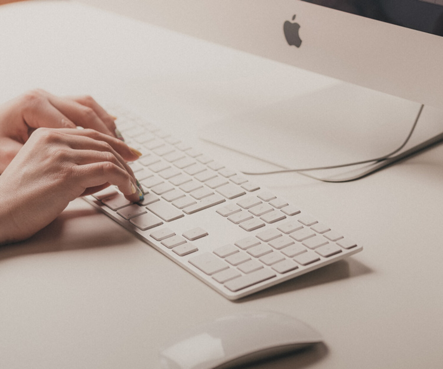 Hands typing on computer