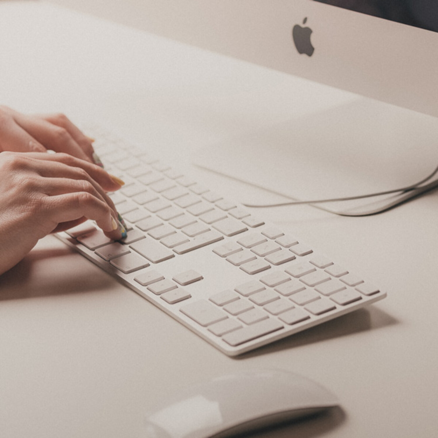 Hands typing on computer